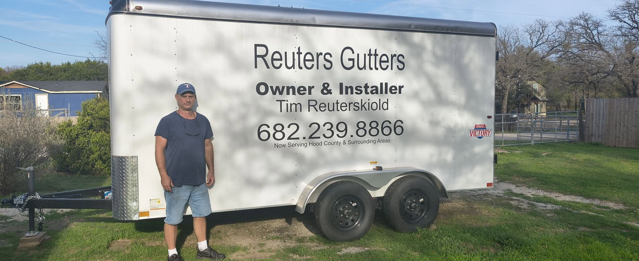 Tim Reuterskiold standing beside the Reuters Gutters work trailer